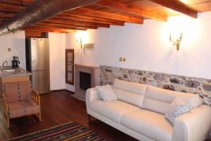 a living room with a couch and a fireplace at Cunda adasında rum evi in Ayvalık