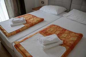 默主歌耶的住宿－Pansion Blue Medjugorje，两张带白色床单和毛巾的床