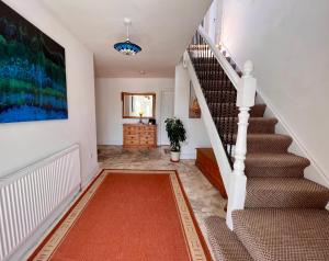 a staircase in a home with a red rug at LOCH CONNELL LODGE in Letterkenny