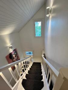 a staircase in a house with a black carpet at Huvila Kyrönniemi in Savonlinna