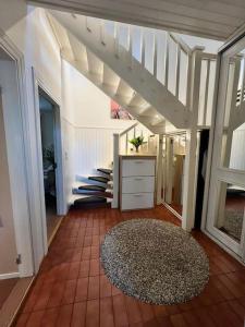 a living room with a staircase and a rug at Huvila Kyrönniemi in Savonlinna