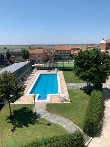 a large swimming pool in a yard with trees at Alacena Alfarera in Pereruela