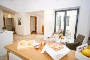 a kitchen and dining room with a table with food on it at Welcome Ostuni b&b in Ostuni