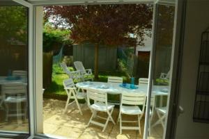 a table and chairs sitting on a patio at Maison St Eloi by iZiLi *Futuroscope*Jardin* in Poitiers