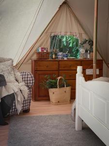 a bedroom with a bed and a tent at Idyllisk glamping rett ved elven in Skien