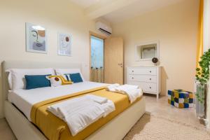 a bedroom with a large bed with towels on it at Sonnino House in Cagliari