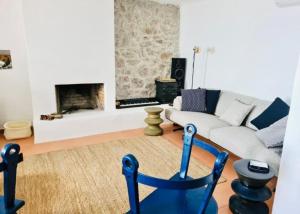 a living room with a couch and a fireplace at Tini’s Home in Vuno