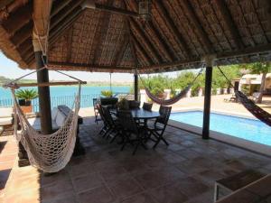 a patio with a table and chairs and a pool at Espectacular casa con embarcadero. in Arcos de la Frontera