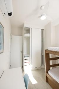a bedroom with two beds and a closet at Itanhaém Praia & Mar in Itanhaém +44 photos