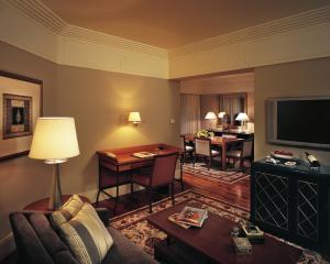 a living room with a couch and a table at The Leela Mumbai in Mumbai