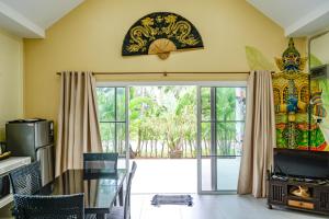 a dining room with a glass door to a patio at Chill Out Village in Ao Nam Mao