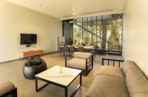 a living room with a couch and a table at Beyond by Sula in Nashik