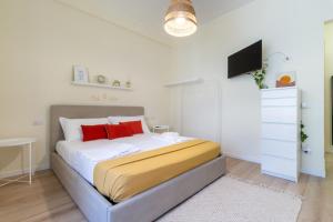 a bedroom with a bed with white and red pillows at Sonnino House in Cagliari