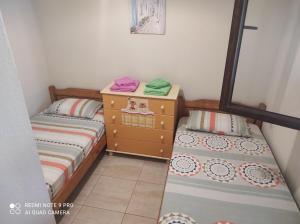 a bedroom with two beds and a dresser at Mary's House in Vourvourou
