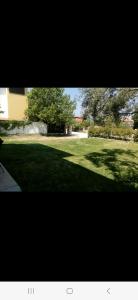 a large grassy yard with trees and a building at Mary's House in Vourvourou +3 photos