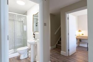 a white bathroom with a toilet and a sink at Wellington Place I Your Apartment in Bristol