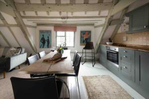 a kitchen and dining room with a table and chairs at Characterful apartment in the heart of Petworth in Petworth