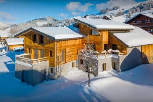 a log home in the snow in the winter at Chalet Mevi - OVO Network in Crest-Voland