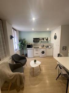 a living room with a couch and a table at Sweet Discovery & Jungle in Bourges