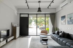 a living room with a couch and a tv at The LINs House in Guiren