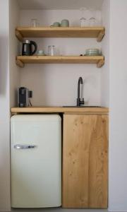 a small kitchen with a sink and a refrigerator at Lyra Sunset Suite in Kampos Paros