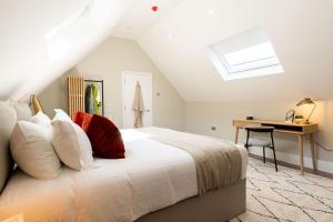 a bedroom with a bed with a desk and a window at Wellington Place I Your Apartment in Bristol