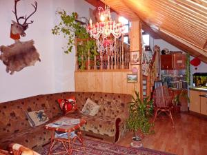a living room with a couch and a chandelier at Sadyba Bilya Richky in Yaremche
