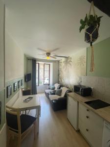 a living room with a couch and a table at Sweet Discovery & Jungle in Bourges