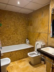 ein Badezimmer mit einer Badewanne, einem WC und einem Waschbecken in der Unterkunft Iris Luxury Apartament in Valencia