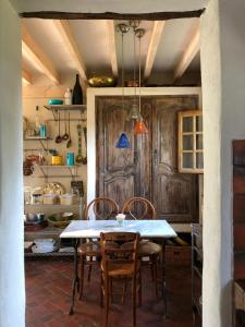 a kitchen with a table and chairs in a room at Maison de Villemaréchal in Paley