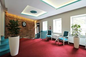 a waiting room with two chairs and a table at City Inn Tbilisi in Tbilisi City