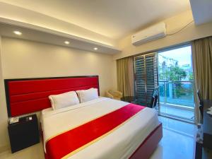 a bedroom with a large bed and a large window at Park Hyatt Dhaka in Dhaka