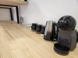 a coffee maker sitting on top of a wooden floor at East Park Inn in Polokwane