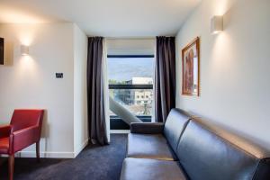 a living room with a couch and a window at Kursaal Hotel in Cattolica