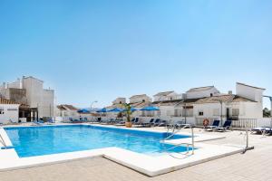 a swimming pool with chairs and umbrellas at a resort at Esencia Vejer in Vejer de la Frontera