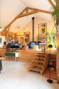 a large room with a store with wooden beams at Les Balcons de la Terrasse in Arsac-en-Velay