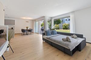 a bedroom with a large bed with blue pillows at The R Apartment Zugerberg - EV Wallbox - Terrasse in Geroldswil