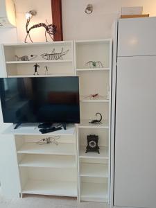 a white entertainment center with a flat screen tv at COSY APARTMENT FILIP IN THE HISTORICAL OLD TOWN in Koper