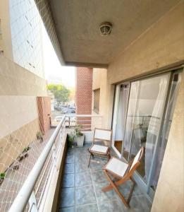 a balcony with two chairs on a building at Live & Work Apart in Buenos Aires city, near park! in Buenos Aires