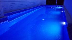 a swimming pool with blue lights in a room at Ibiscus and Lily Apartments in Rhodes Town