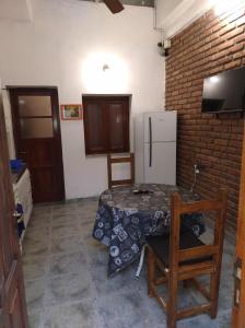 a kitchen with a small table and a refrigerator at Departamento Zona Centro Ubicado A 1 Cuadra De La Terminal De Ómnibus De Catamarca in San Fernando del Valle de Catamarca