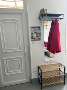 a room with a door and a shelf with clothes at T2 maison entre calme & ville in La Riche