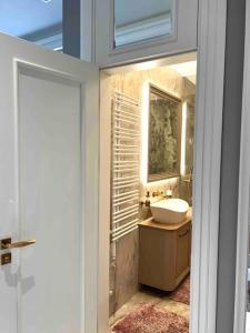 a bathroom with a sink and a mirror at Studio apartment in the center of Riga in Riga