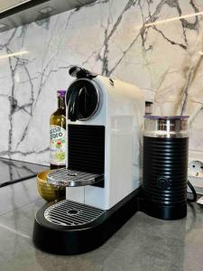 a white toaster sitting on a counter with a drink at Studio apartment in the center of Riga in Riga