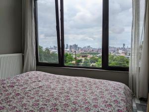 a bedroom with a bed and a view of a city at Гостевой дом с красивой панорамой на город in Batumi