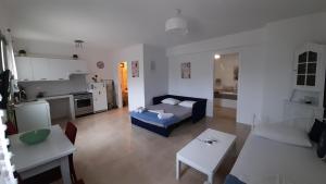 a living room with a couch and a kitchen at Magda house in Livadion