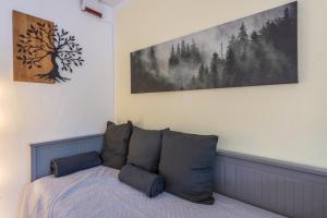 um quarto com uma cama com almofadas em Kloster Meister Haus Apartment 12 em St. Blasien