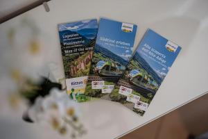three brochures on top of a table at Mia Rooms - Room with private bath Bolzano Center in Bolzano