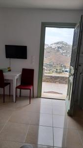 a room with a table and a window with a view at Magda house in Livadi