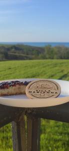 a piece of cake sitting on a plate on a fence at Villa Marianna in Vasto